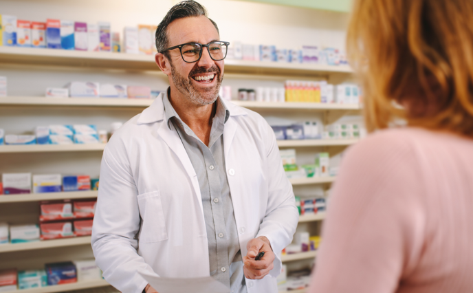 Pharmacist greeting a customer