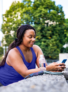 Woman standing outside and texting on a cell phone
