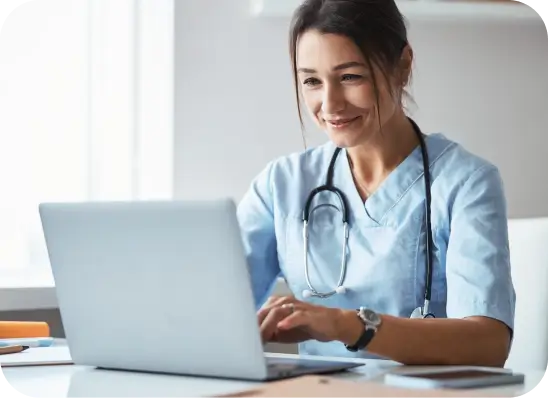 Female doctor looking at a laptop