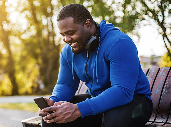 Man with headphones using his phone