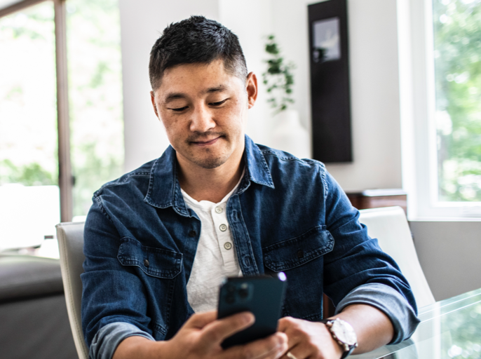 Man sitting at table and texting