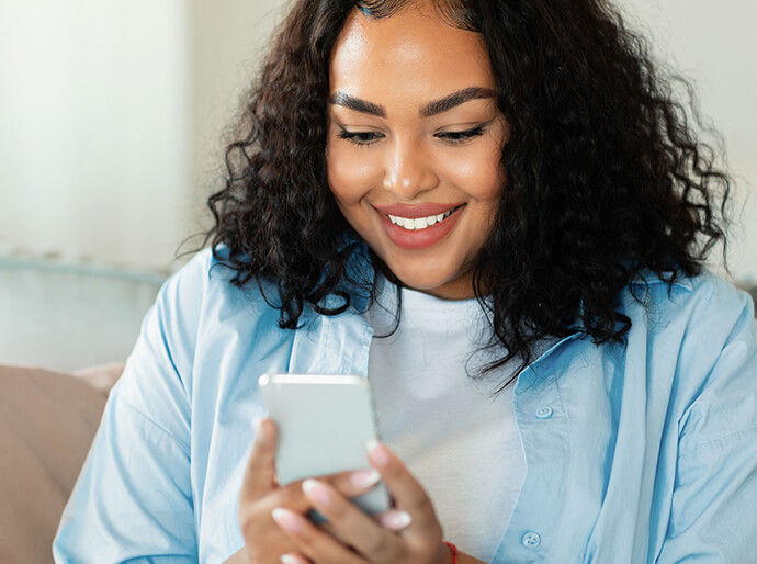 Woman smiling looking at phone