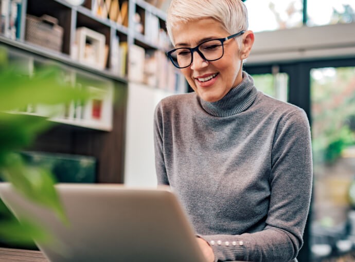 Woman smiling and using a laptop