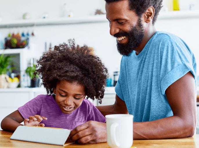 Father and son playing on tablet