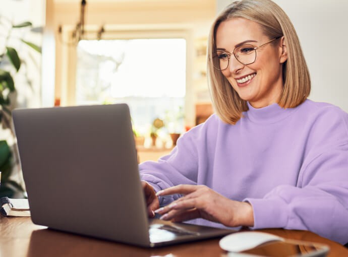 Woman smiling and using a laptop
